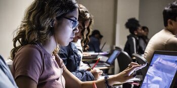 Psychology student in classroom with laptop