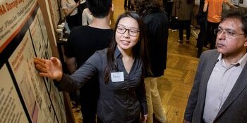 undergraduate student presenting research at symposium