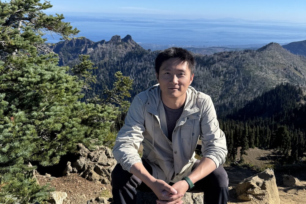 Dr. Zhang on top of a mountain